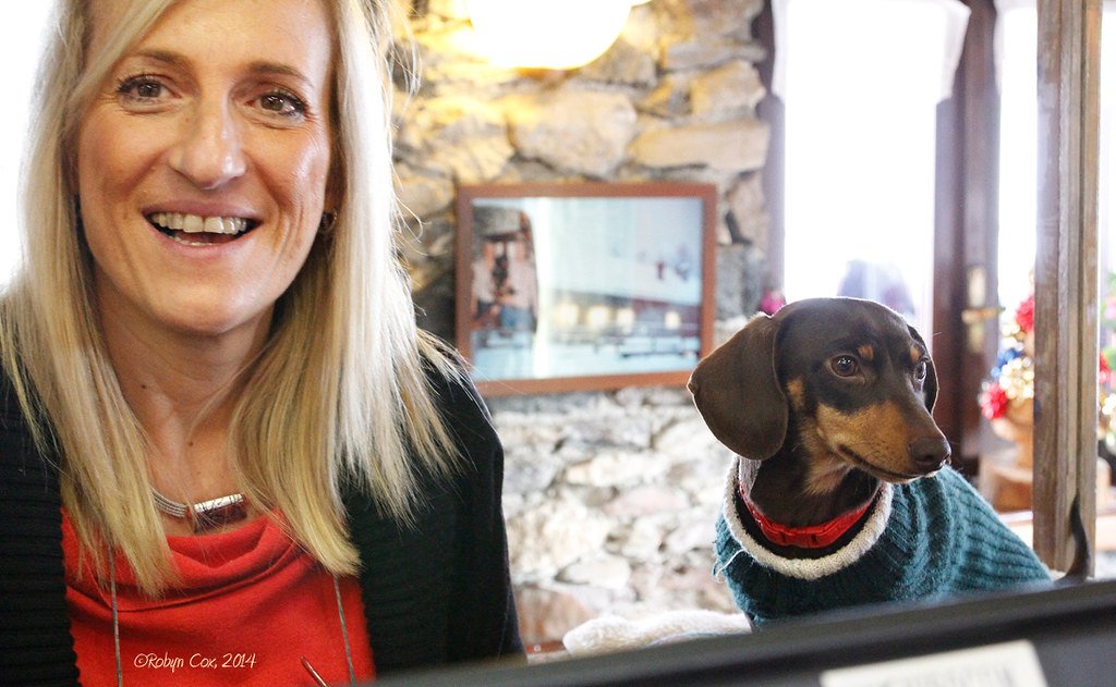 woman and dog in restaurant